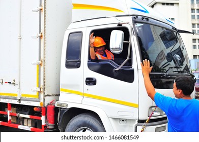 Truck Driver Waving Hand To Colleagues.