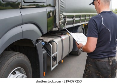 The Truck Driver Works With A Tablet To Monitor The Inspection Of The Truck And The Cargo Being Transported. Cargo Inspection. The Trucker Checks The Technical Condition Of The Truck. Close-up