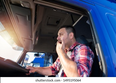 Truck Driver Yawning While Driving. Trucker Feeling Sleepy And Tired After Long Ride. Overworked People At Job.