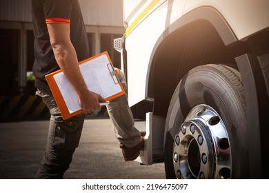 Truck Drivers Holding Clipboard Checking Truck Wheels Tires.  Maintenance Checklist Wheels Tyre. Truck Inspection Safety Driving. Freight Truck Transport.	
