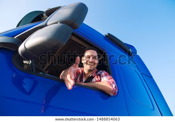 Truck\
drivers job openings. Truck driving careers. Middle aged\
professional trucker driver sitting in his vehicle cabin and giving\
a shaking hand to new recruits. Drivers\
wanted.