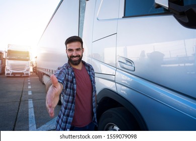 Truck Drivers Job Openings. Middle Aged Professional Trucker Driver Standing In Front Of His Truck And Giving Shaking To New Recruits. Truck Driving Careers.