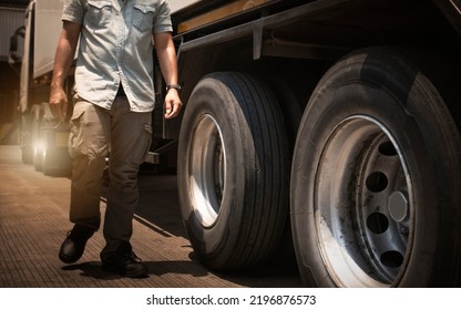 Truck Drivers Walking And Checking The Semi Truck's Maintenance. Inspection Safety Truck Wheels Tires. Freight Truck Transport. Auto Service Shop.	