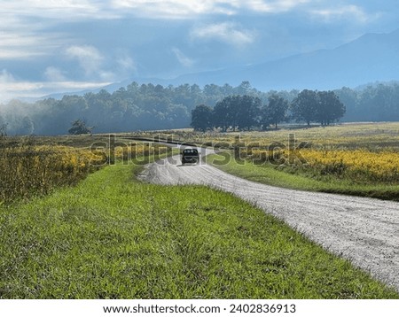 A truck drives down a the gravel road away from Abrams Falls in Cades Cove at the Great Smoky Mountains National Park