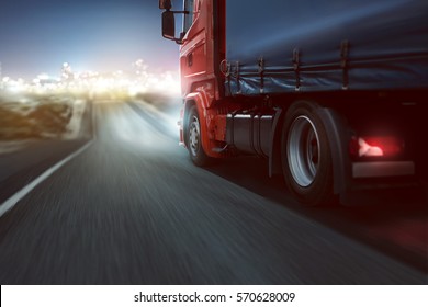 Truck Drives On A Country Road With Bokeh Lights In The Distance