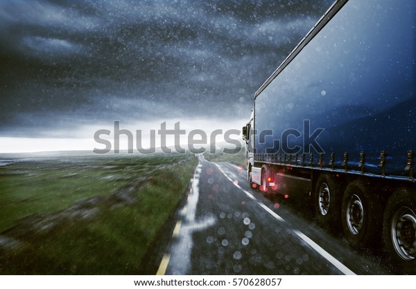Truck drives through the\
rain