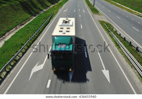 The\
truck is driving along the highway in a sunny\
day