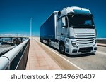 Truck driving on bridge on a sunny summer day