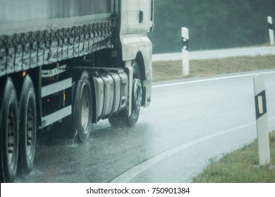 A Truck Is Driving On The Road In The Rain