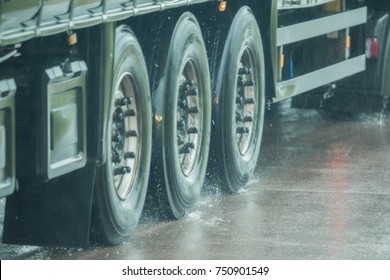 A Truck Is Driving On The Road In The Rain