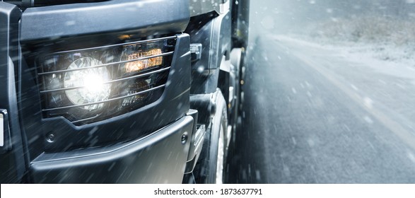 The Truck Is Driving On A Winter Road. Close-up Of Headlights