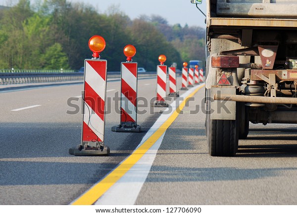 Truck\
driving through road works / dangerous\
situation