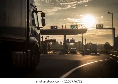 Truck driving to toll booth - Shutterstock ID 1158776722