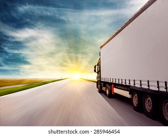 Truck Driving Towards Sunset