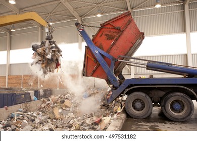 Truck dumps waste to the incinerator, grab take the rubbish - Powered by Shutterstock