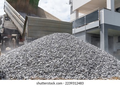 Truck emptied gravel on construction site - cant grain, broken gravel, construction machine - Shutterstock ID 2239312483