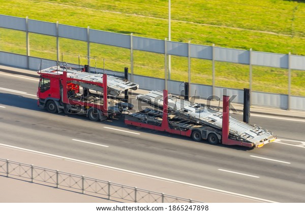 Truck with empty double-deck trailer for\
transporting new cars