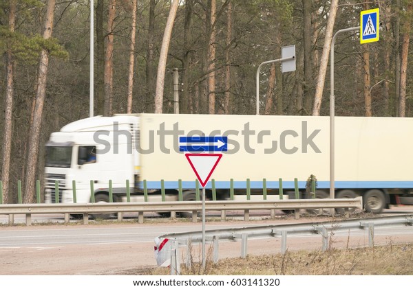 Truck\
fast moving on the road with road sign \