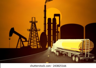 Truck With Fuel Tank On The Highway Into Oil Rig And Beautiful Sunset Sky In Concept Of Industrial Petrochem