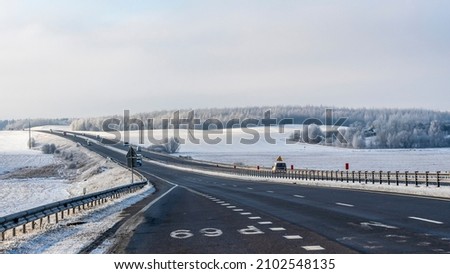 Truck goes on winter road. Van in the road of winter. Lorry car and cold landscape. Roadway and route snowy street trip. Winter road transportation truck. Logistic concepts.