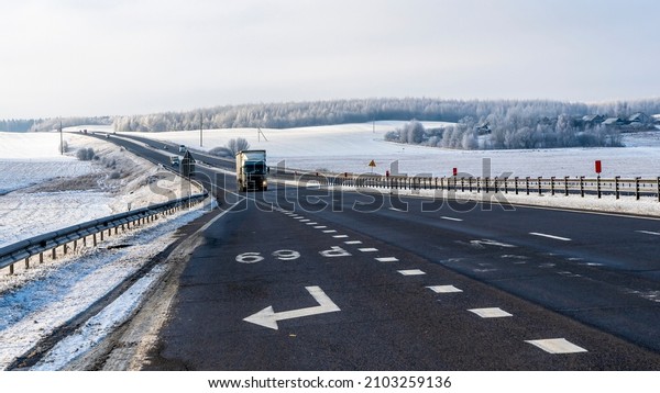 Truck goes on\
winter road. Van in the road of winter. Lorry car and cold\
landscape. Roadway and route snowy street trip. Winter road\
transportation truck. Logistic\
concepts.
