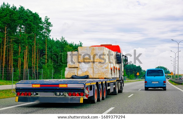 Truck in the highway road in Warsaw,\
Poland. Lorry transport delivering some freight\
cargo.