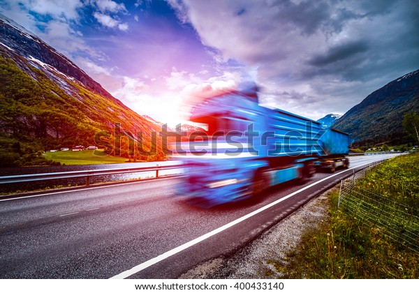 Truck\
and highway at sunset. Truck Car in motion\
blur.