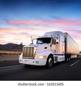 Truck and highway at sunset - transportation background