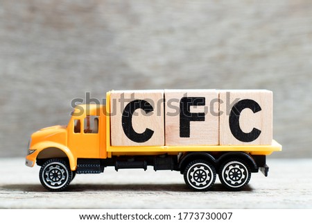 Truck hold letter block in word CFC (abbreviation of Chlorofluorocarbon) on wood background