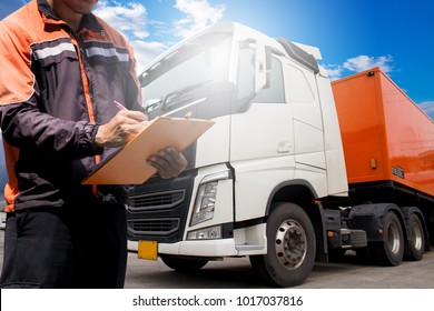 Truck inspection repairing and maintenance. truck driver hand writing on clipboard. daily checking safety semi truck. lorry. trailer