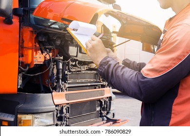 Truck Inspection And Safety. Truck Driver Is Checking Truck Engine.