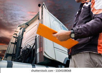 Truck Inspection And Safety. Truck Driver Holding Clipboard Is Checking Safety A Truck.