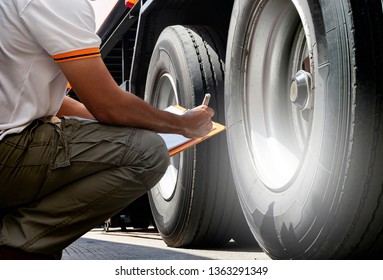 Truck Inspection And Safety, Truck Driver Is Inspecting Wheels And Tires Truck