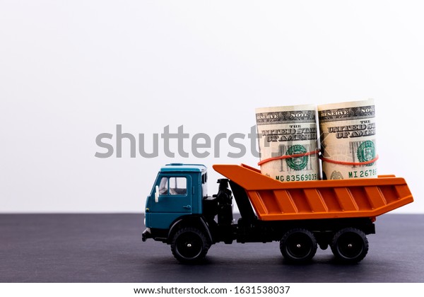 Truck with a
load of money on a black
background
