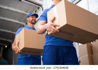 Truck Movers Loading Van Carrying Boxes And Moving House