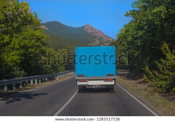truck moves through
a winding mountain road