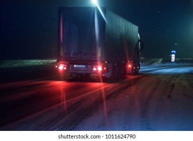 Truck Is Moving Along The Winter Road At Night