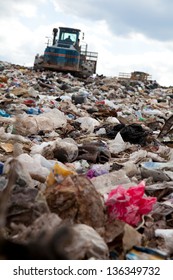 Truck Moving Garbage In A Landfill Site