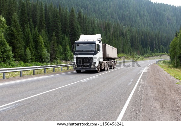 The truck is
moving on the mountain forest
road