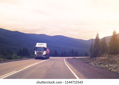 The Truck Is Moving On The Mountain Road At Sunset