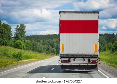 A  Truck With The National Flag Of Indonesia
 Depicted On The Back Door Carries Goods To Another Country Along The Highway. Concept Of Export-import,transportation, National Delivery Of Goods 