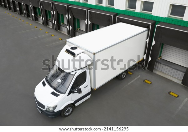 Truck near loading dock of warehouse outdoors,\
aerial view. Logistics\
center