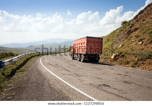 The truck on Highway Mountain Road.\
Container on the big highway. transport\
loads