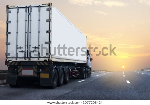 Truck on\
highway road with white container, transportation\
concept.,import,export logistic industrial Transporting Land\
transport on asphalt expressway with sunrise\
sky