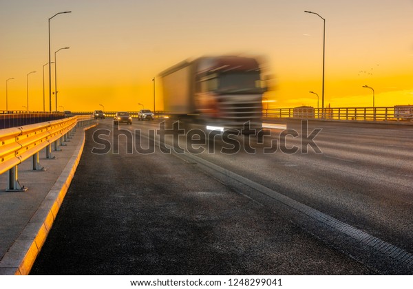truck on the highway at\
sunset