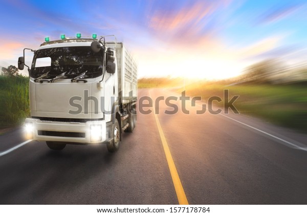Truck on motorway in beautiful sunset light.\
On the road transportation and\
cargo.