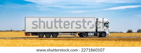 Truck on the road with blue sky and white clouds background.