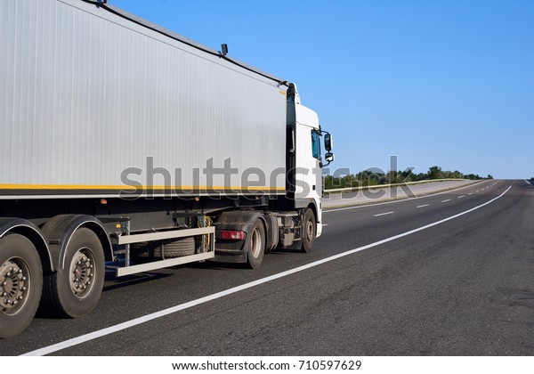 Truck on road with container, cargo transportation\
concept, closeup object