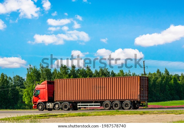 Truck on the road with red container. Cargo\
shipping and transportation\
concept.