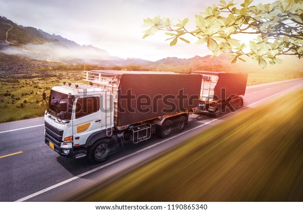 Truck on the road at\
sunset.